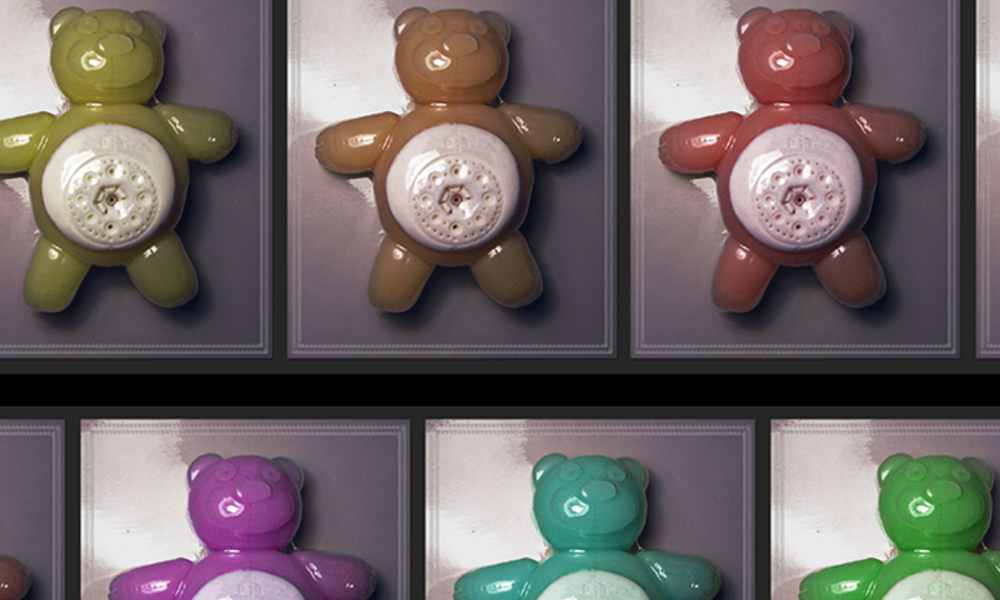 Grid of glossy colourful teddy bear figurines with white circular discs on their bellies